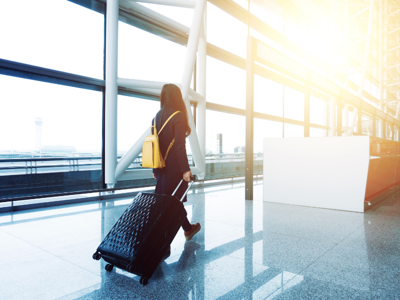 woman airport walking sunrays