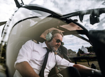 pilot preparing for take off with helicopter