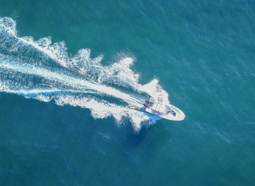 Motorboat driving fast from above