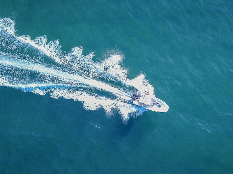 Motorboat driving fast from above