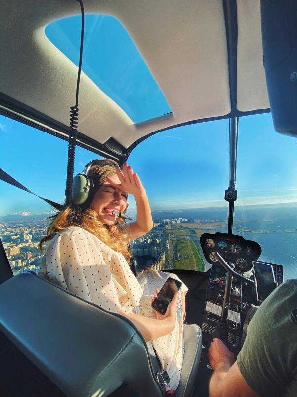 young woman turning around in helicopter