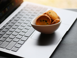 Bowl of cookies placed on a laptop